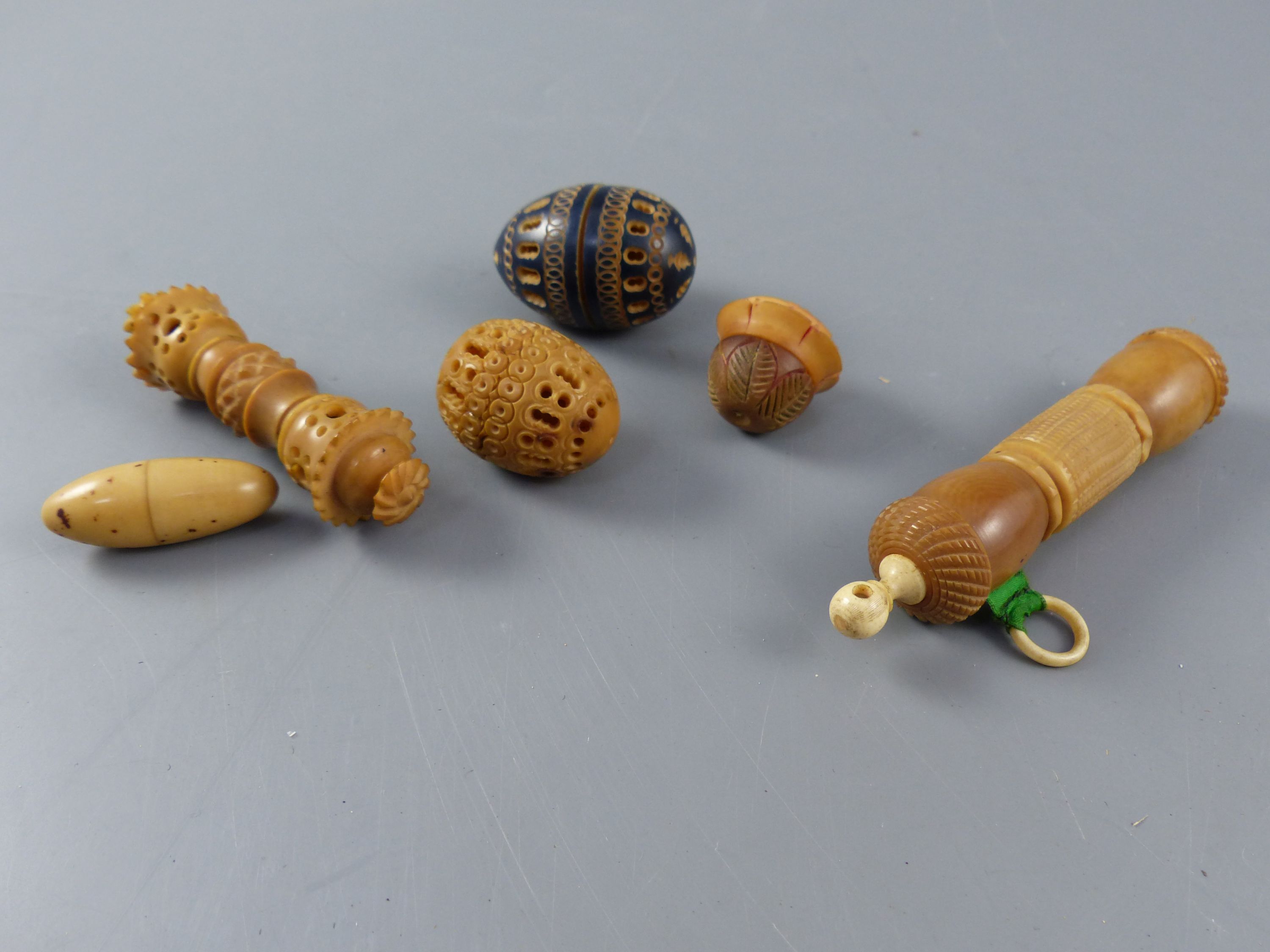 A collection of assorted 19th century carved and turned coquilla nut sewing accessories